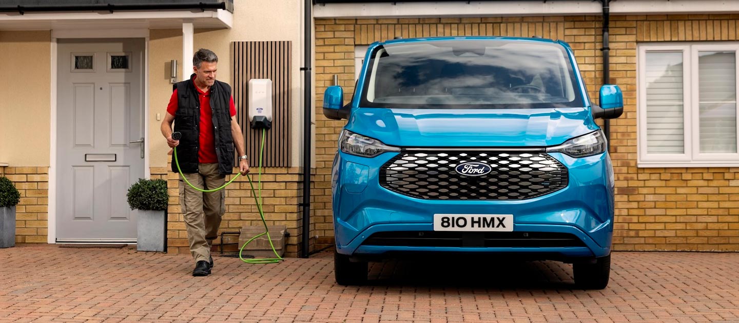 A family having fun while charging their electric Ford Explorer with an outdoor EV home charger.