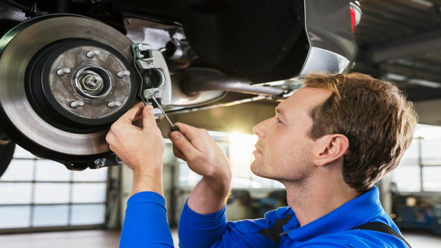 Ford worker holding an engine model