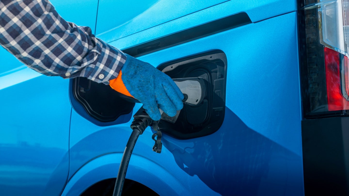 Close-up of a hand charging the car