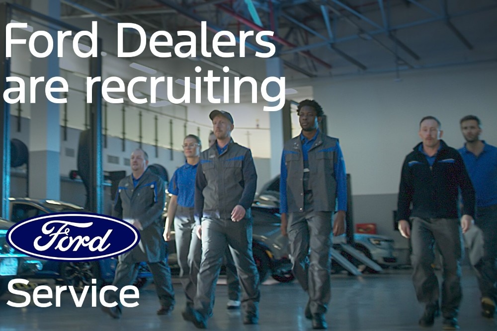 Ford technicians walk towards the camera in a dealership garage. The text "Ford Dealers are recruiting"; and the Ford service logo are displayed.