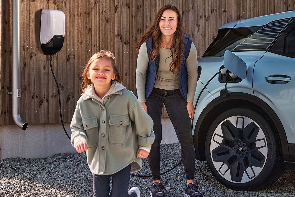 A family having fun while charging their electric Ford Explorer at home.