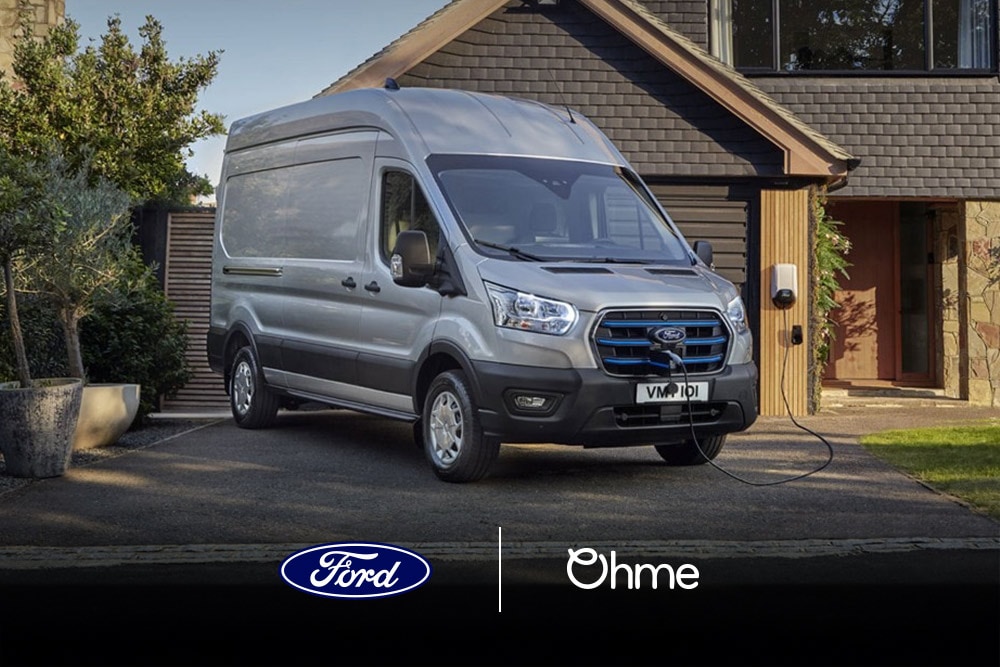 Silver Ford van charging at home. Ford and Ohme logos visible.