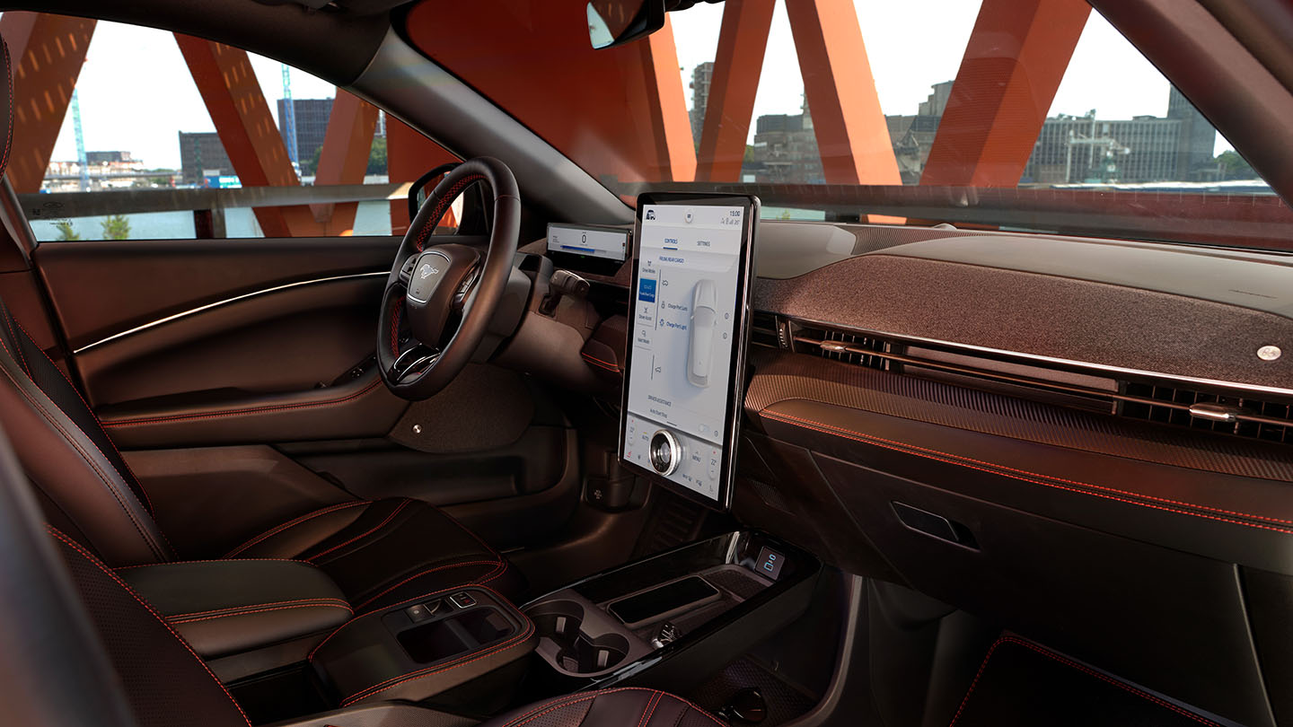 The interior of the Ford Mustang Mach-E, showing the 15.5" SYNC 4 touchscreen and stylish interior finish.