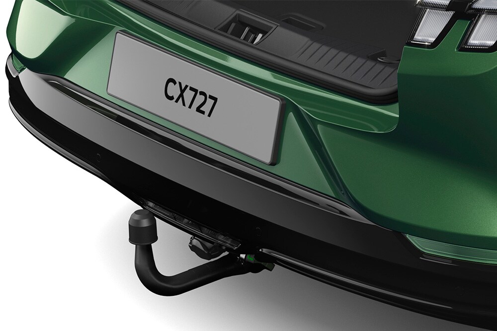 A close up of the electric tow bar on a green Ford Mustang Mach-E, photographed in a studio on a white background.