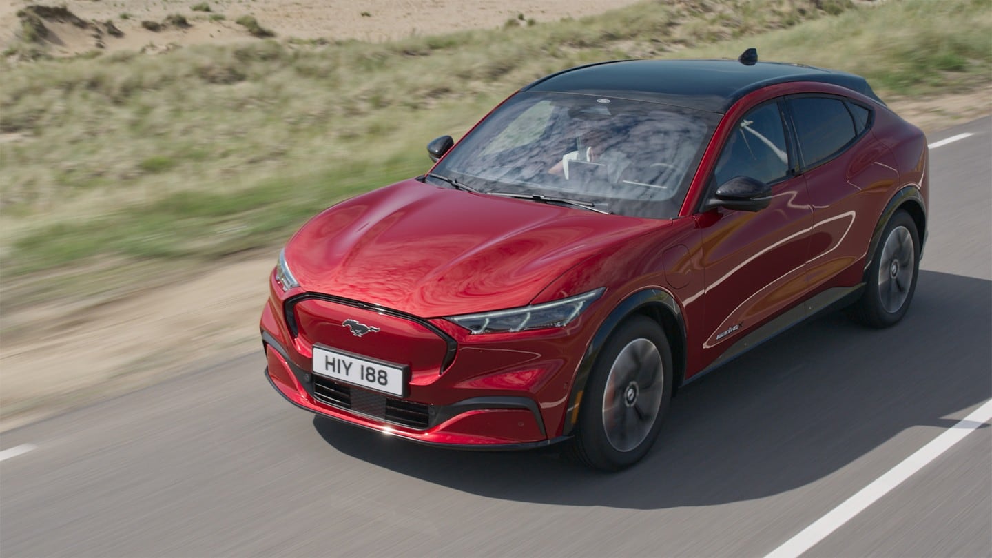 Red Ford Mustang Mach-E driving on the road