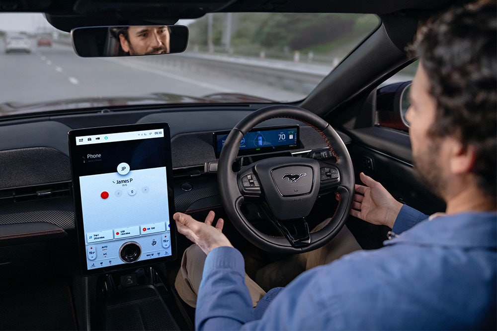 Person behind driving wheel of Mustang Mach-E