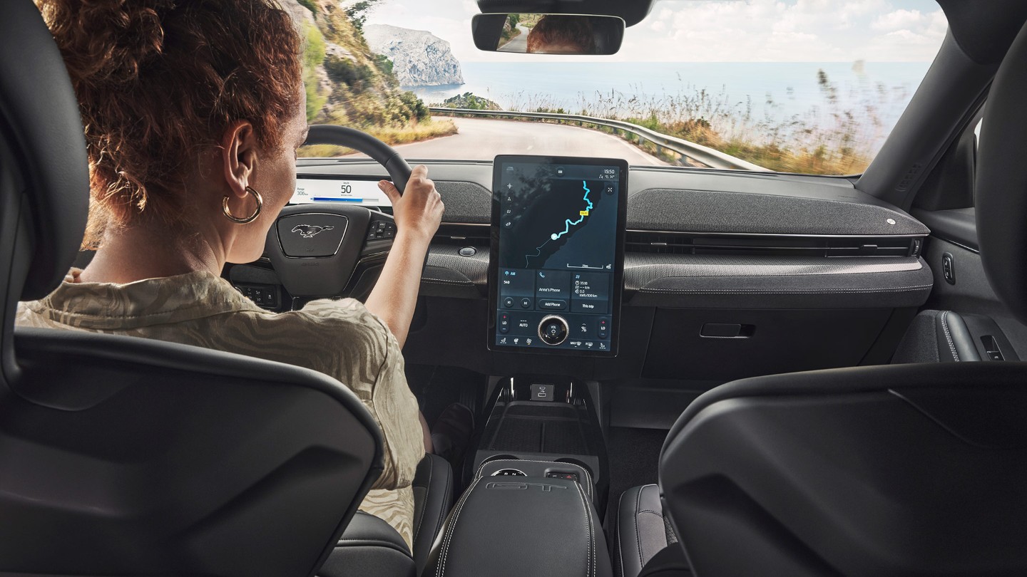 Driver using the SYNC 4 touchscreen in an All-New Ford Mustang Mach-E