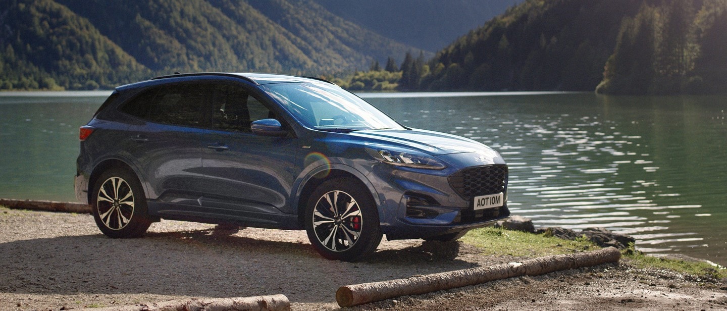 Ford Kuga parked in the mountains near a lake