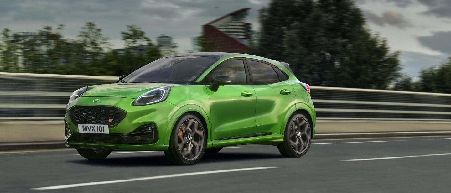 Green Ford Puma ST side view view driving on road