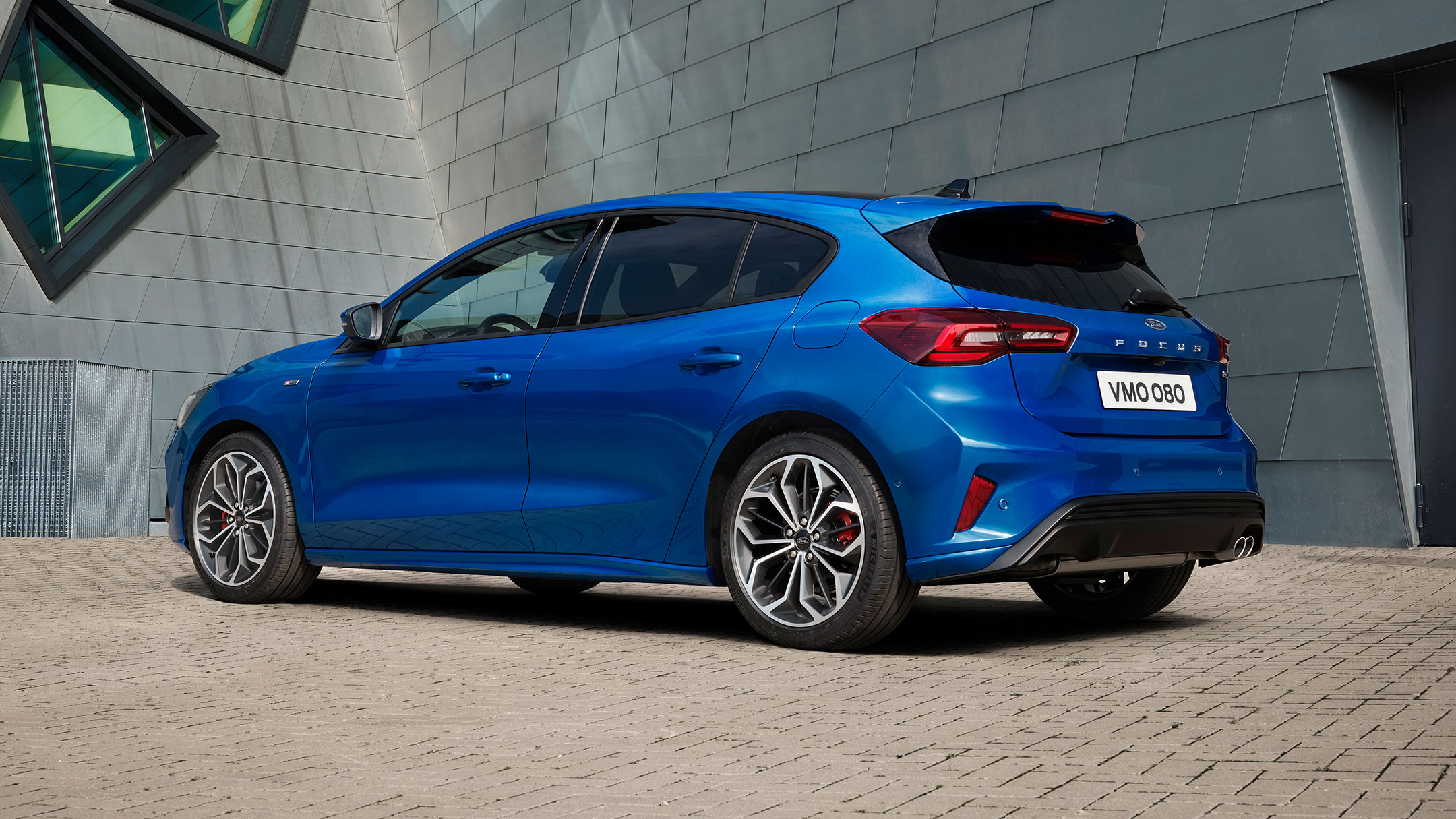 Rear 3/4 view of a blue Ford Focus