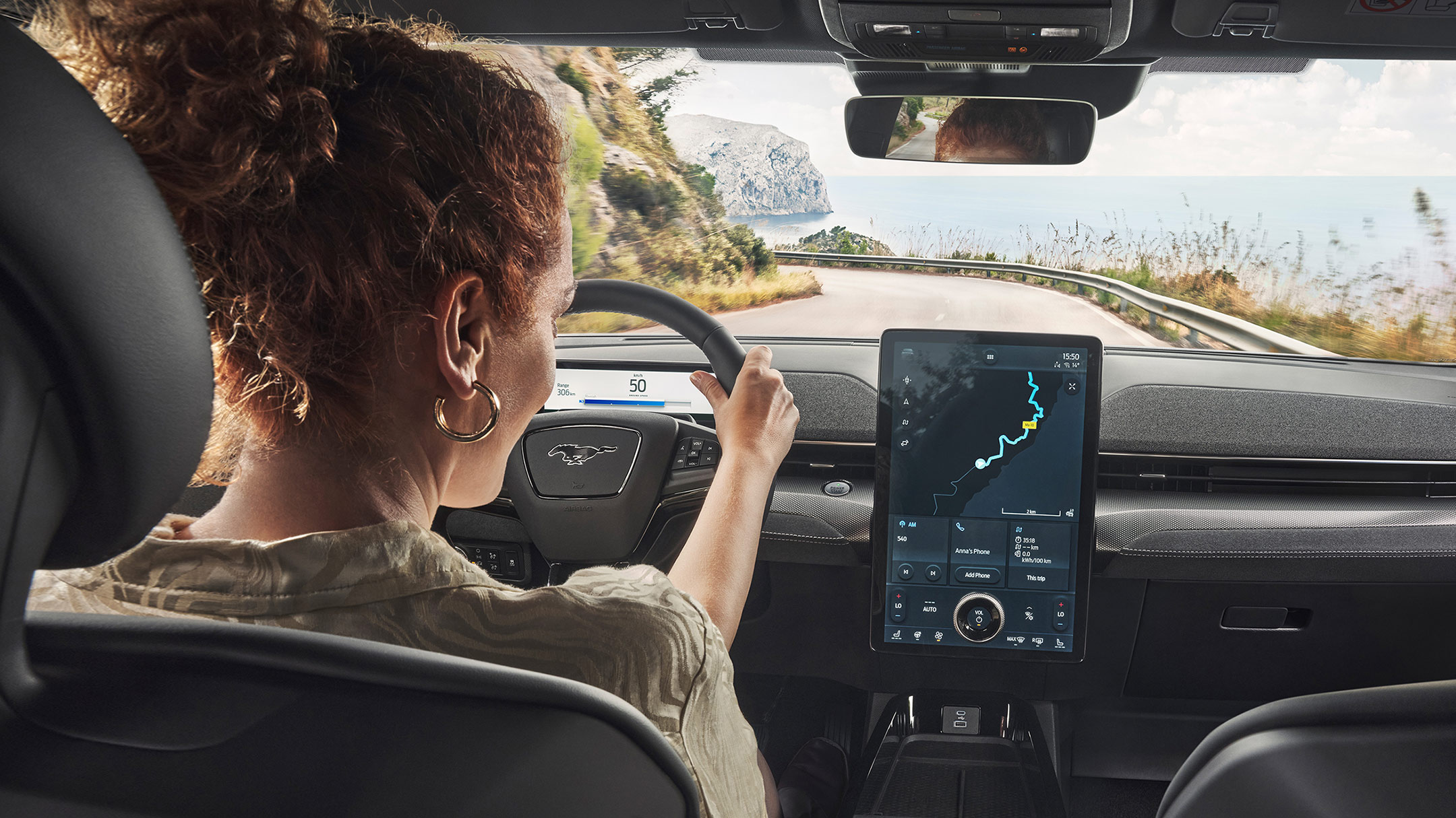 A woman using the SYNC 4 touchscreen in a Ford Mustang Mach-E