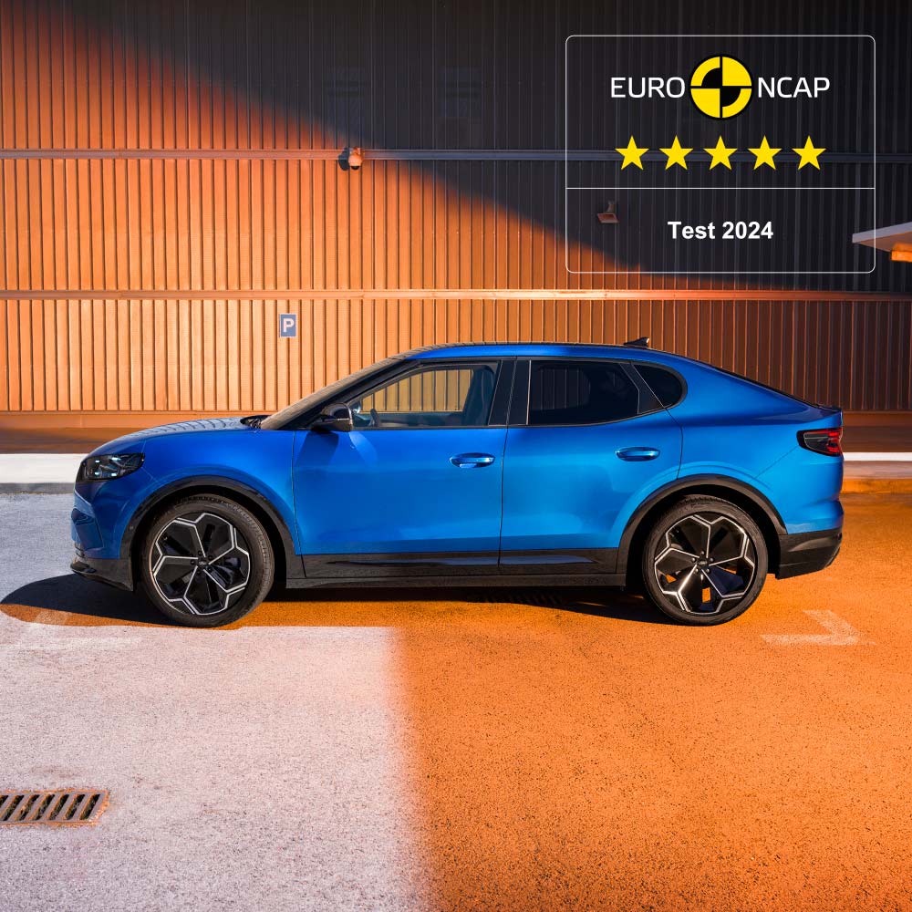 A side view of a blue Ford Capri. The 2024 Euro NCAP 5-star safety rating is displayed in the top right corner.