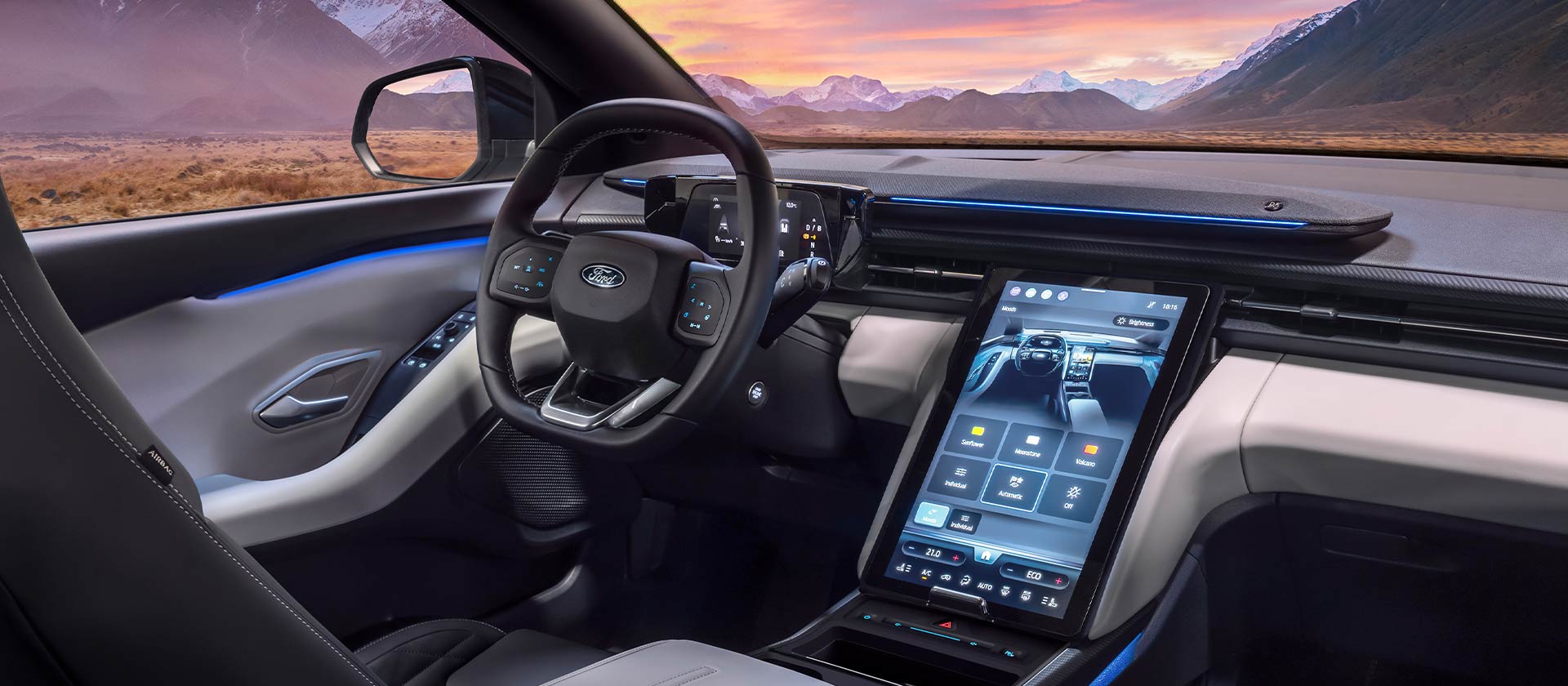 A close up of the dashboard of the Ford Explorer, showing the steering wheel and large 14.6" SYNC Move touchscreen. 
