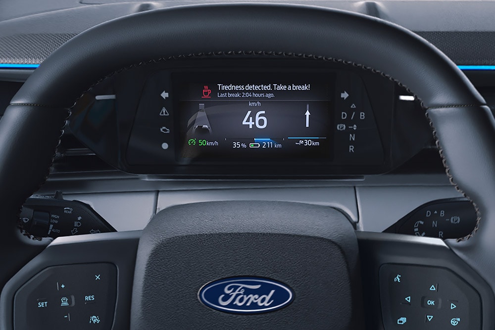 The digital instrument cluster behind the steering wheel of the Ford Explorer, showing the Driver Alert feature.