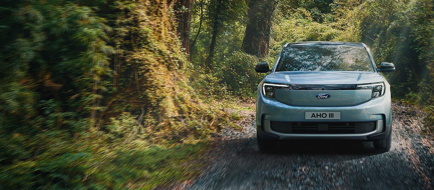 A rear view of Ford Explorer® driving through a forest