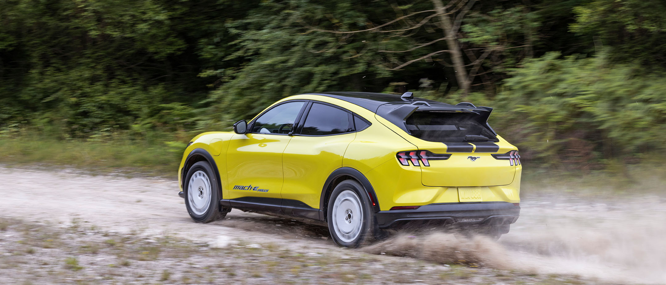 Ford Mustang Mach-E Rally driving on a dirt road