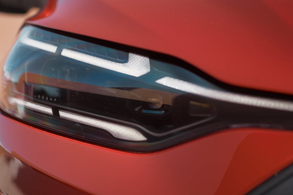 Close-up of a red Ford vehicle's Matrix LED headlight.