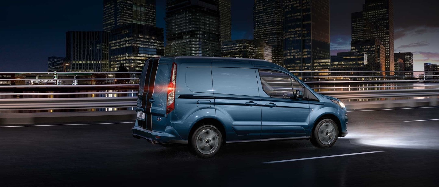 New Blue Ford Transit Connect driving in city