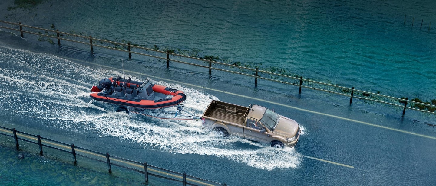 New Ford Ranger Regular Cab towing a boat in water New Ford Ranger Regular Cab towing a boat in water