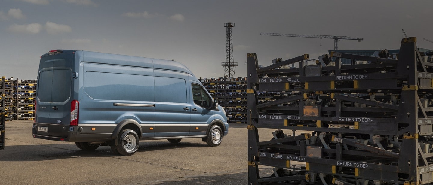 New Blue Ford Transit Van rear view on road