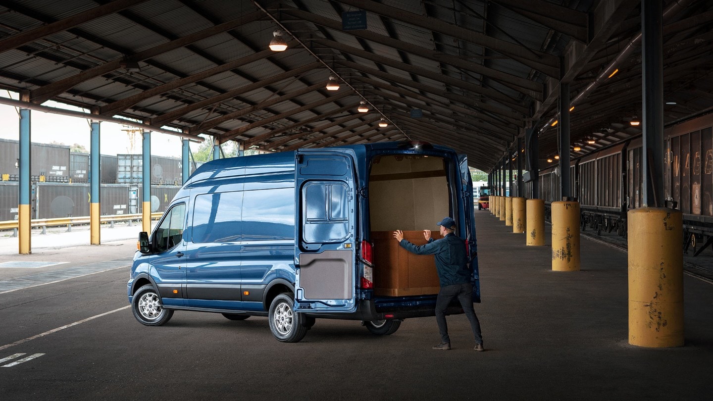 New Blue Transit Van rear view with man loading