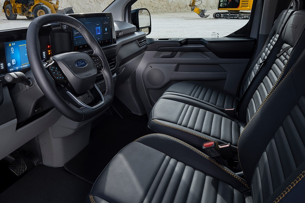 Interior of a Ford E-Transit Custom Sport electric van with black and gold seats.