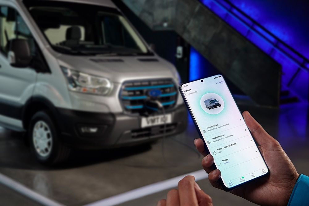 Person uses the FordPass app to check charging status of a Ford E-Transit.