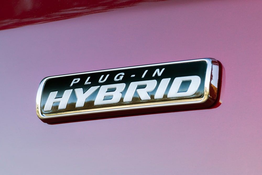 Close-up of Plug-in Hybrid badge on a red Ford Transit Custom.