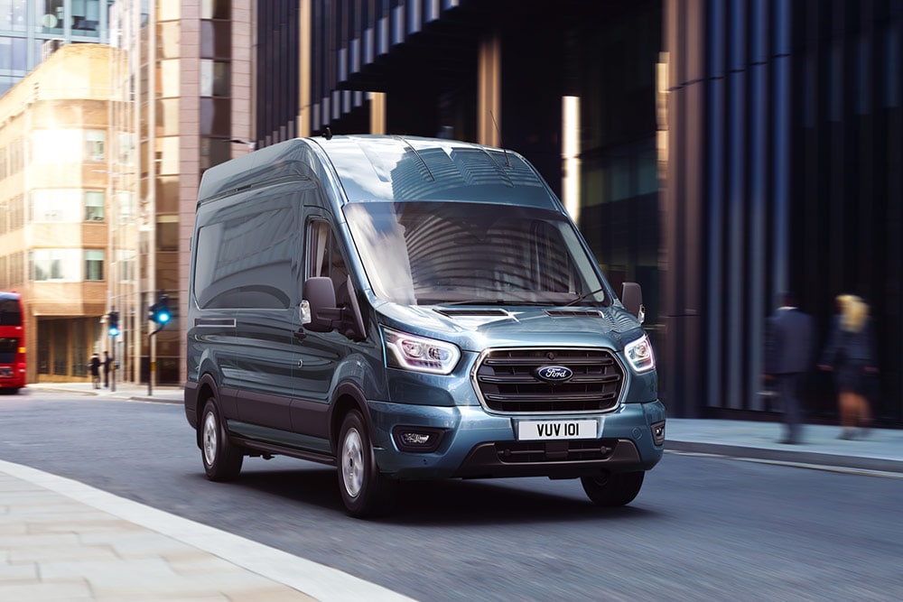 New Ford Transit Courier driving on a city street.
