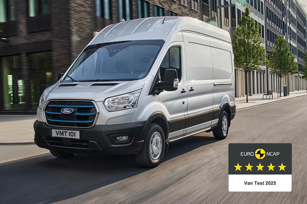 Silver Ford E-Transit electric van driving on a road with a "Gold 2022 Commercial Van Safety" badge.