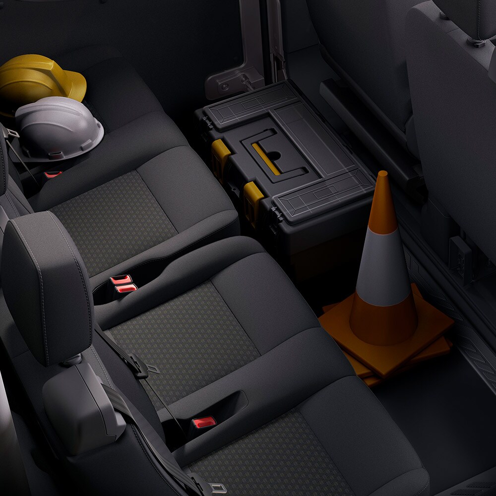 A row of dark gray seats with headrests and seatbelts.