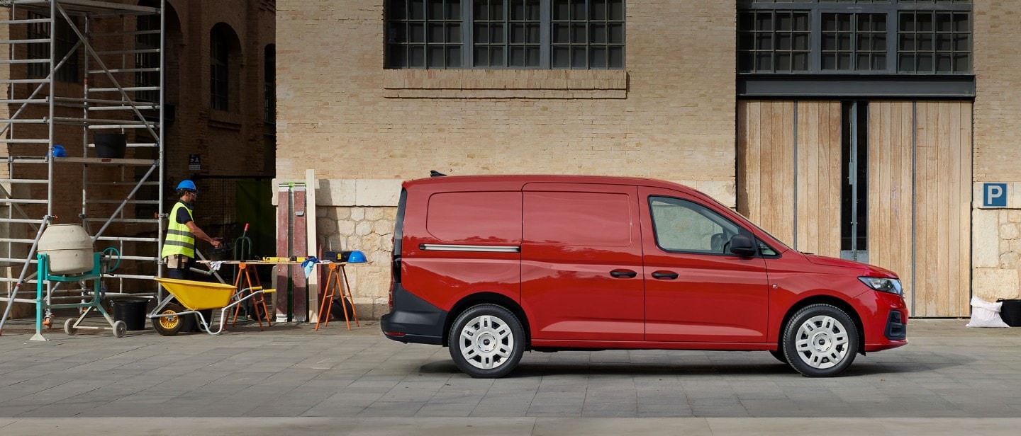 All-New Ford Transit Connect in Maple Red is parked amongst a building site showing side loading door.