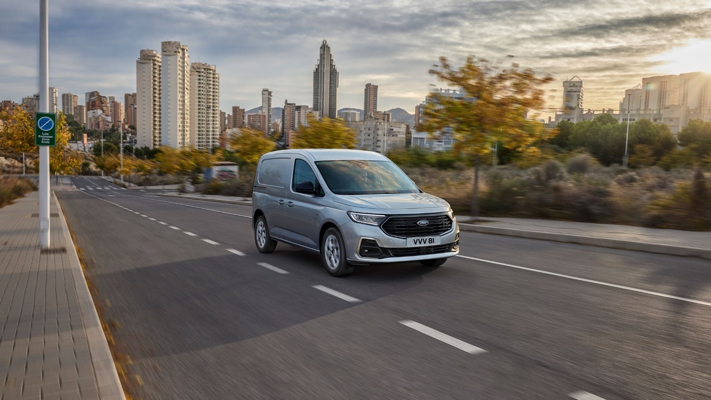 All-New Ford Transit Connect in Stardust Silver drives along a road.