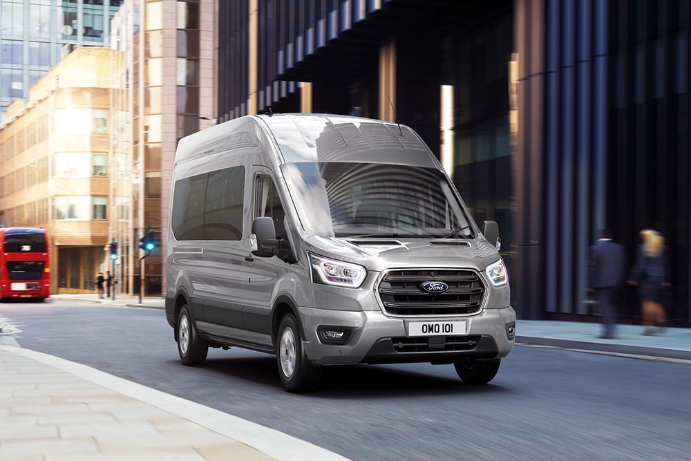  Ford Transit Kombi driving in city.