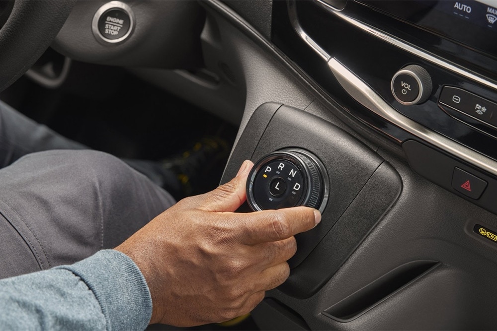  Hand moving rotary shift gear in the centre console of Ford Transit Van. 