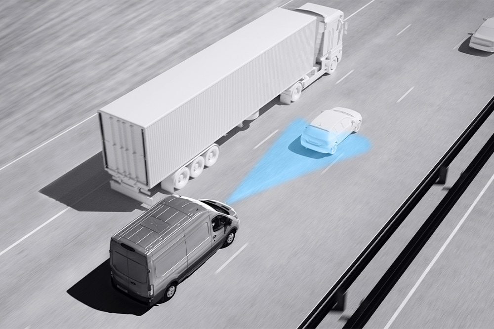  Greyscale drawing of a Ford Transit Van with blue lines on road depicting use of Advanced Driver Assistance Systems.