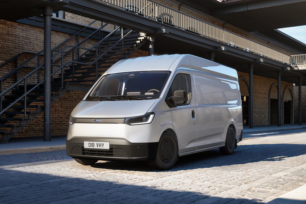 White All-New Ford Transit City® L2H2 van parked in in front of a brick building.