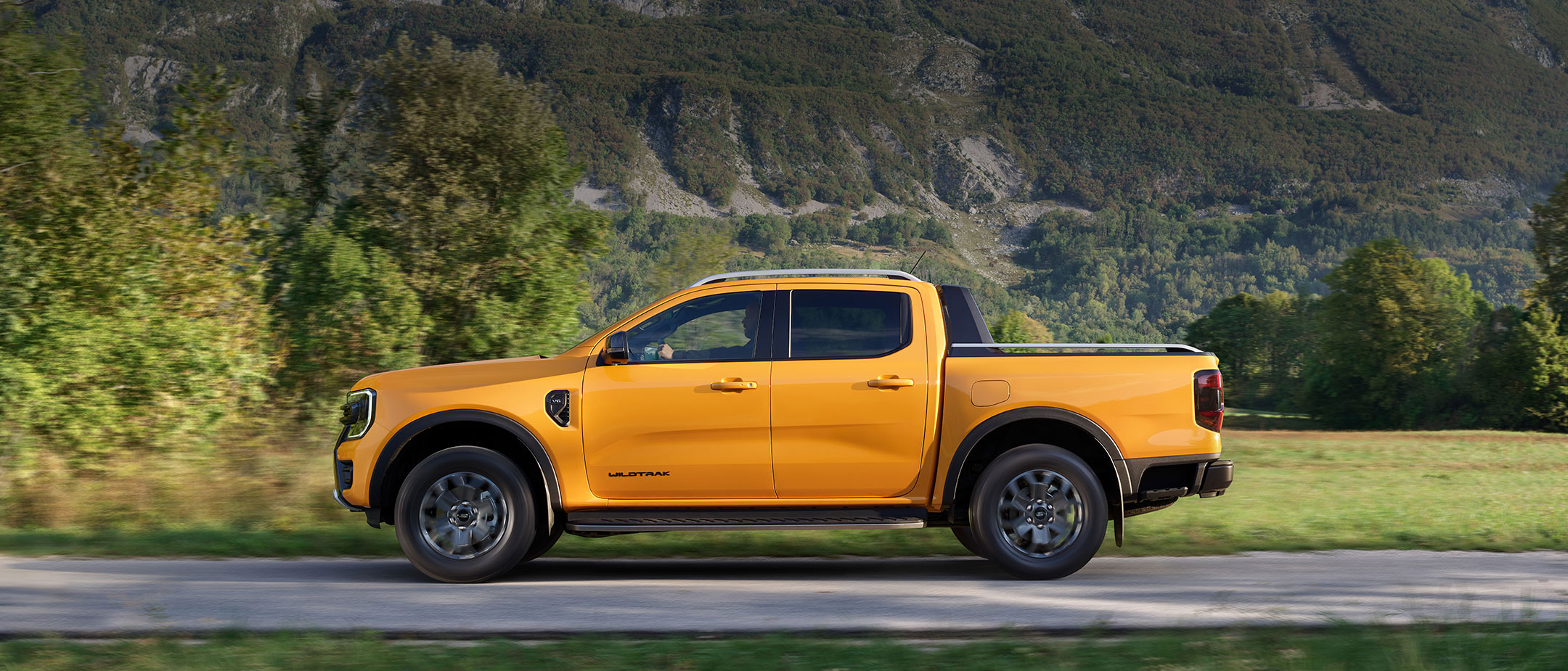 Ford Ranger side view driving on county road