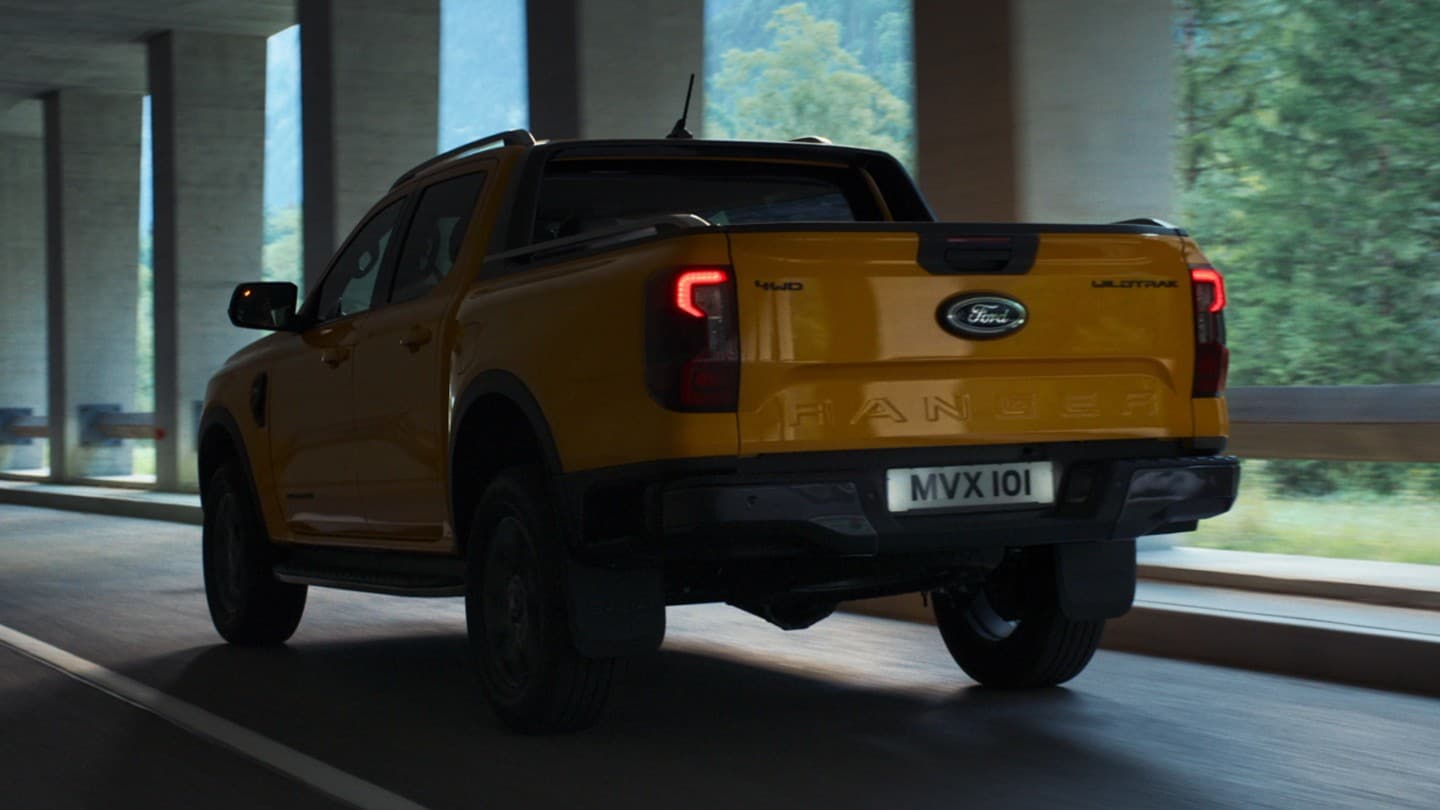 Ford Ranger rear 3/4 view driving under overpass