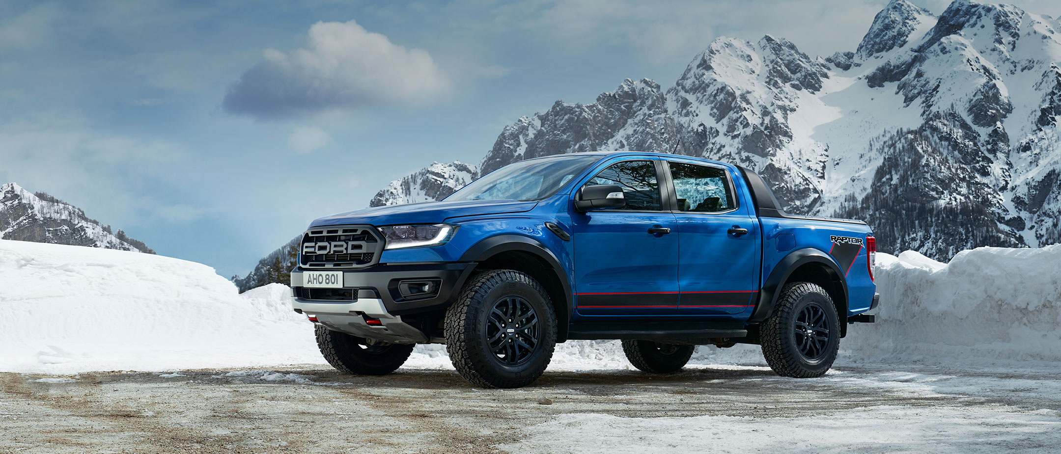 Blue Ford Ranger Raptor parked on snowy mountains Blue Ford Ranger Raptor parked on snowy mountains