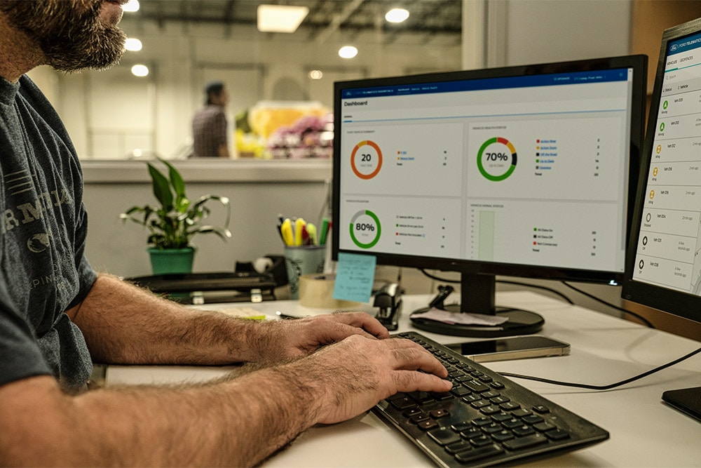 VIDEO – Man on a desktop in an office setting, looking at vehicle data.