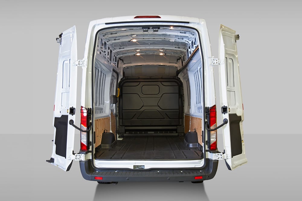 Rear view of the inside of a white Ford Pro Transit van.