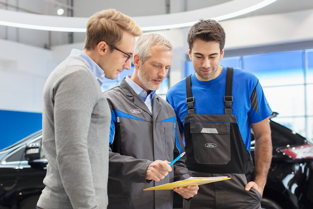 Three experts discuss off-the-shelf vehicle options at a Ford Transit Centre.