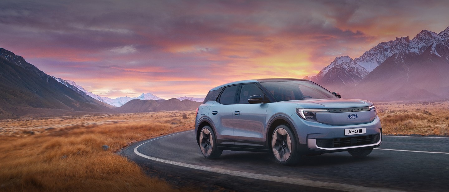 Ford Explorer® on a mountain road with a sunset at horizont