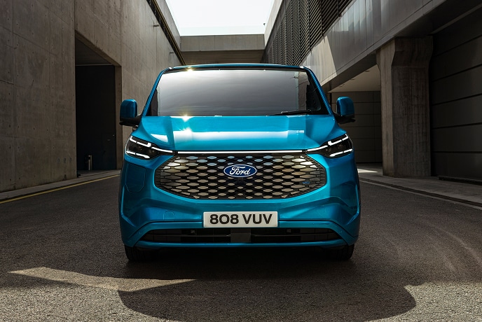A front view of a blue electric Ford E-Transit Custom van.