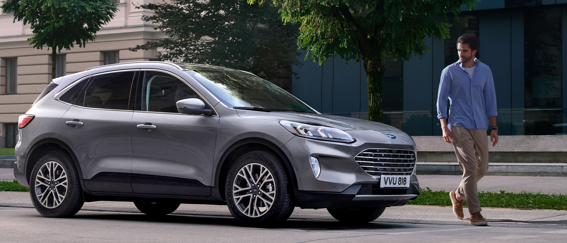 Man walking near parked Kuga