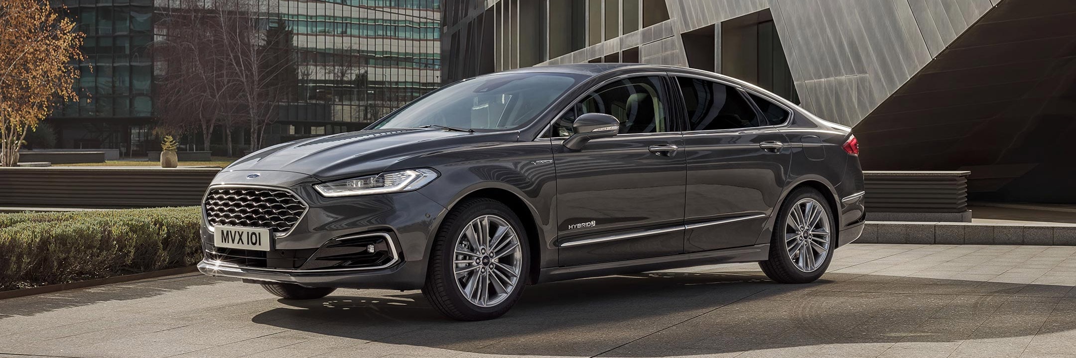 Grey Ford Mondeo parked in front of buildings