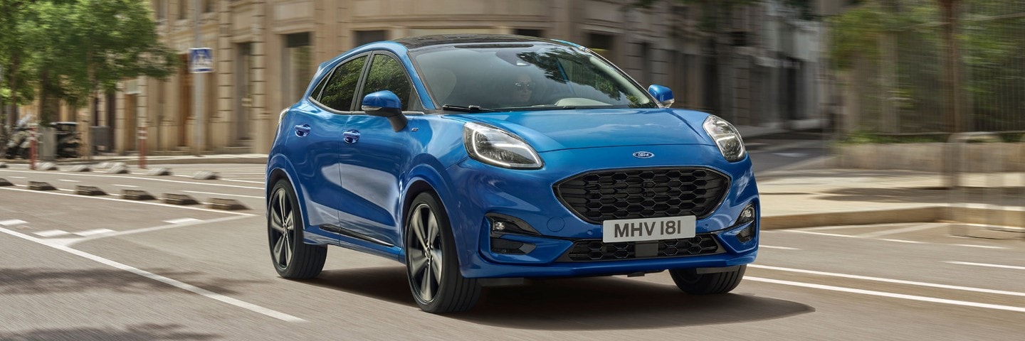 Blue Ford Puma driving on the streets