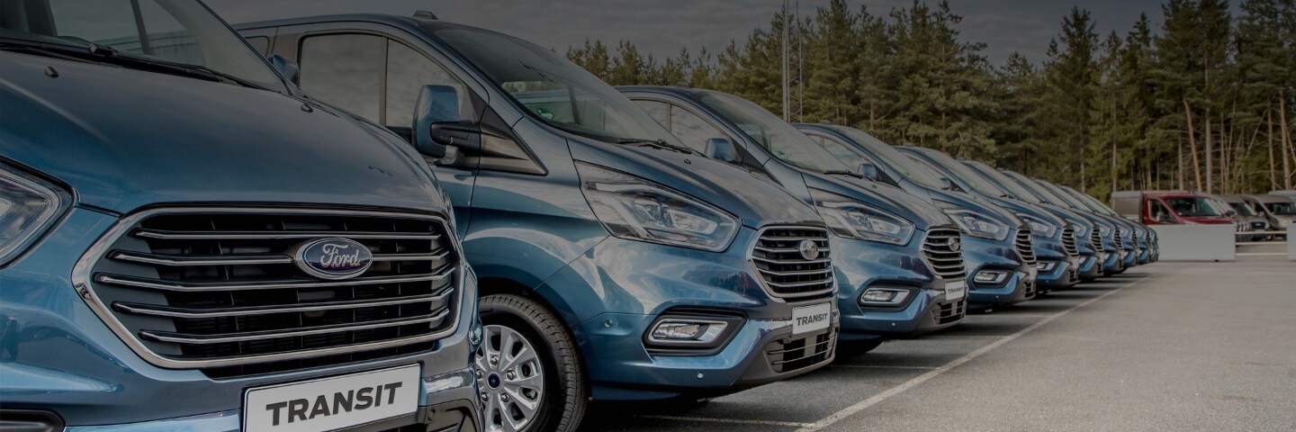 Blue Ford Transit vans parked