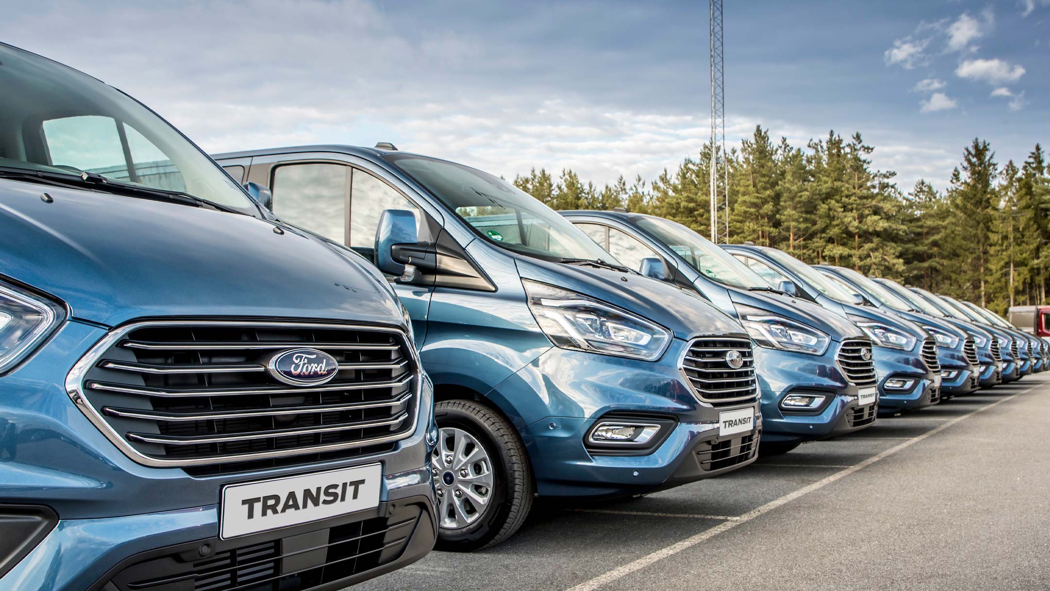 Blue Ford Transit vans parked